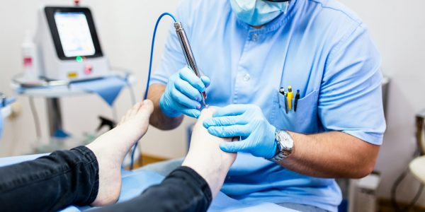 Toenail fungus treatment with foot laser at laser nail therapy clinic. Toenail fungus treatment with foot laser at laser nail therapy clinic.