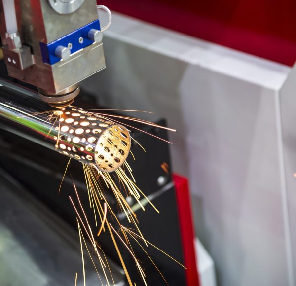 The CNC laser cut machine cutting the stainless pipe or tube.Industrial 4.0 concept for modern manufacturing process. The CNC laser cut machine cutting the stainless pipe or tube.Industrial 4.0 concept for modern manufacturing process.